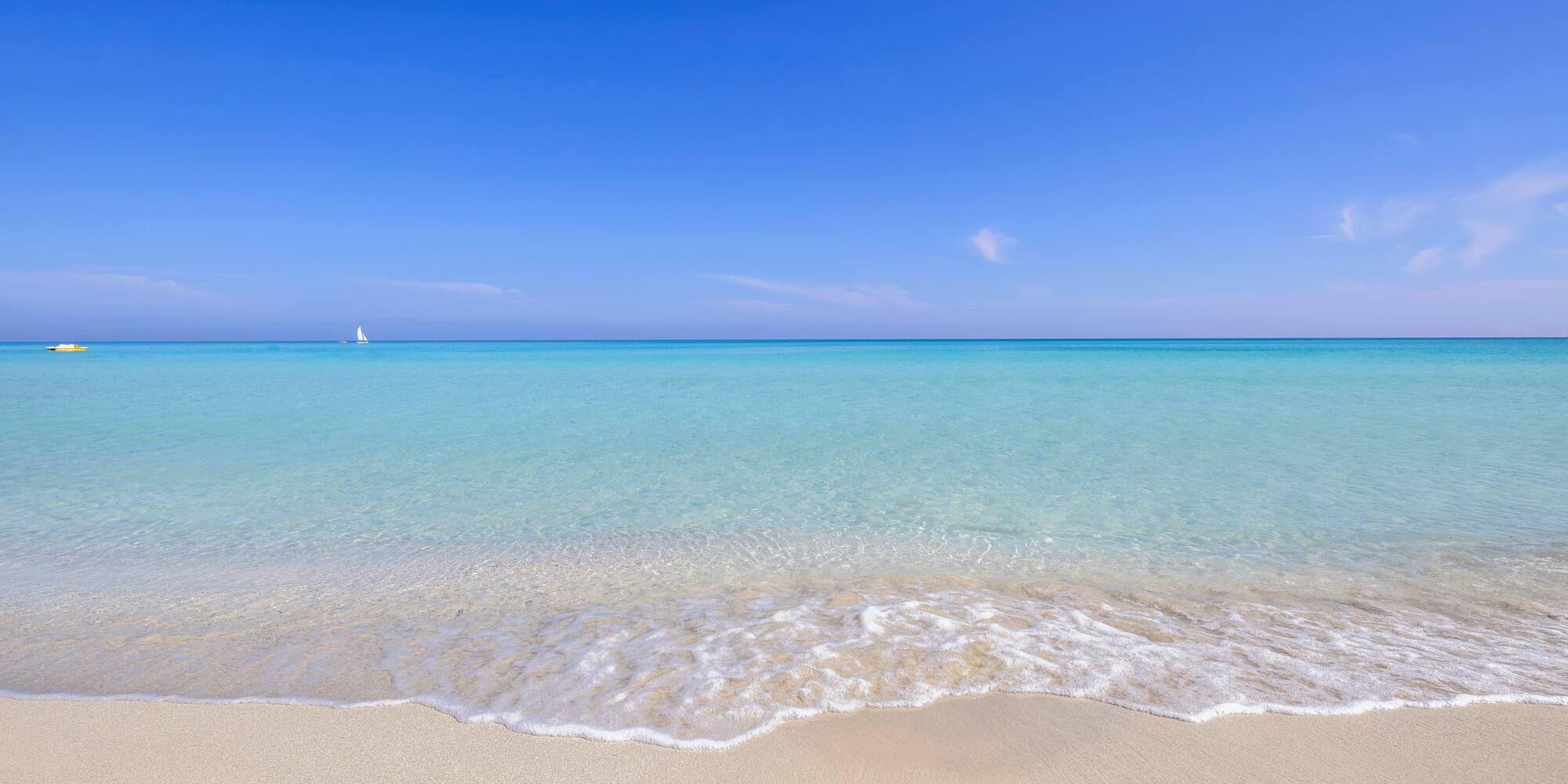 a beach with clear blue water