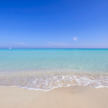 a beach with clear blue water