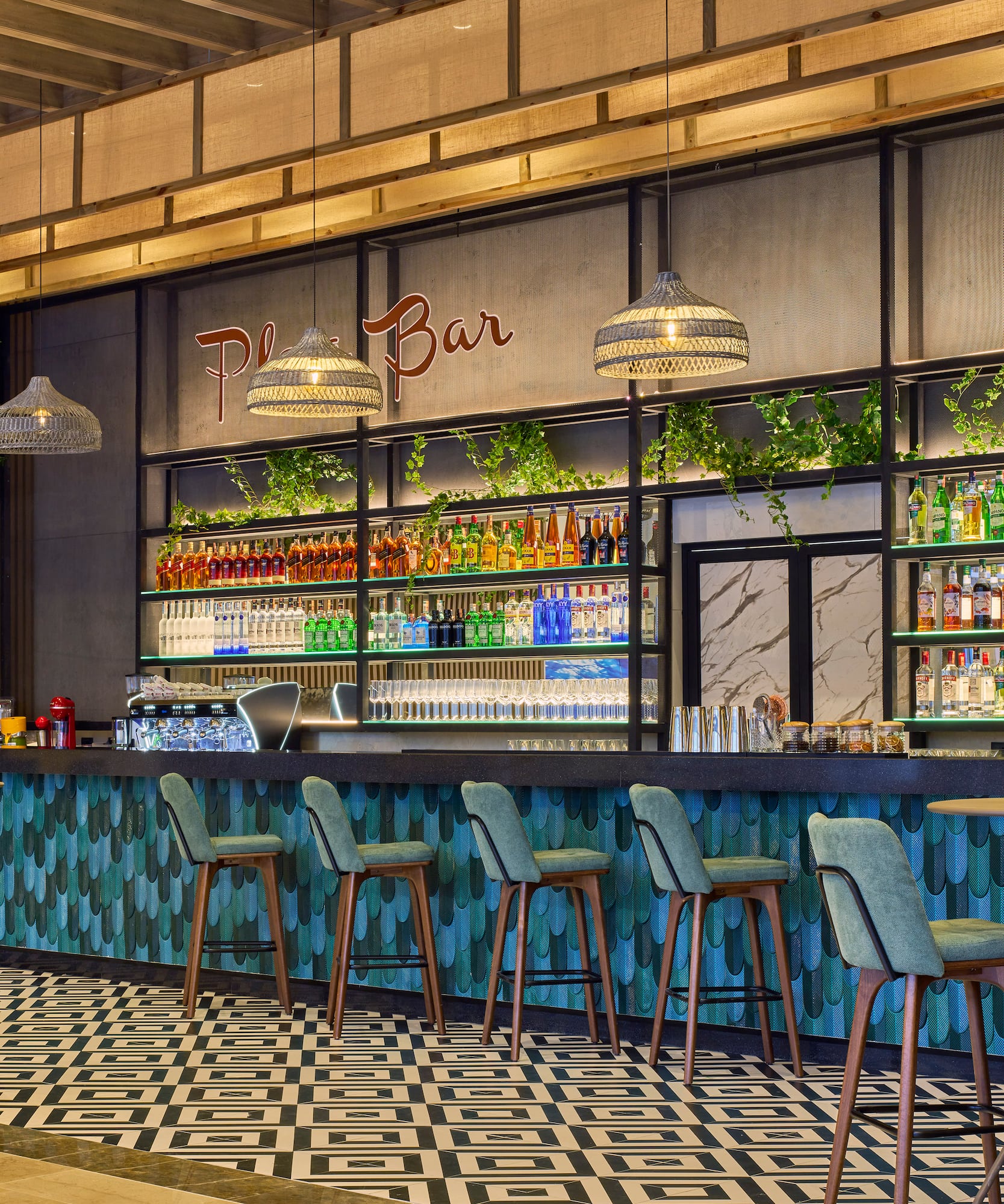 a bar with bottles of drinks and chairs