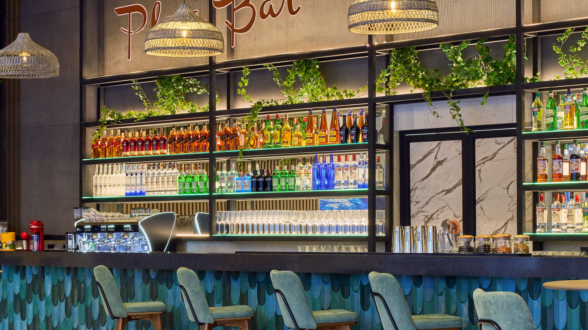 a bar with bottles of drinks and chairs