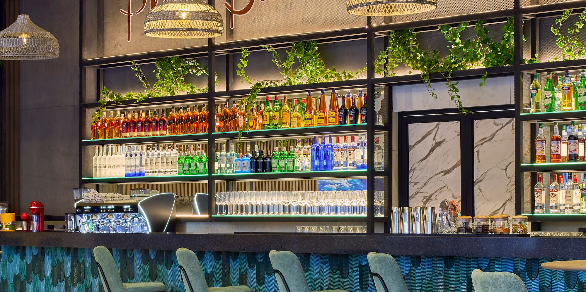 a bar with bottles of drinks and chairs