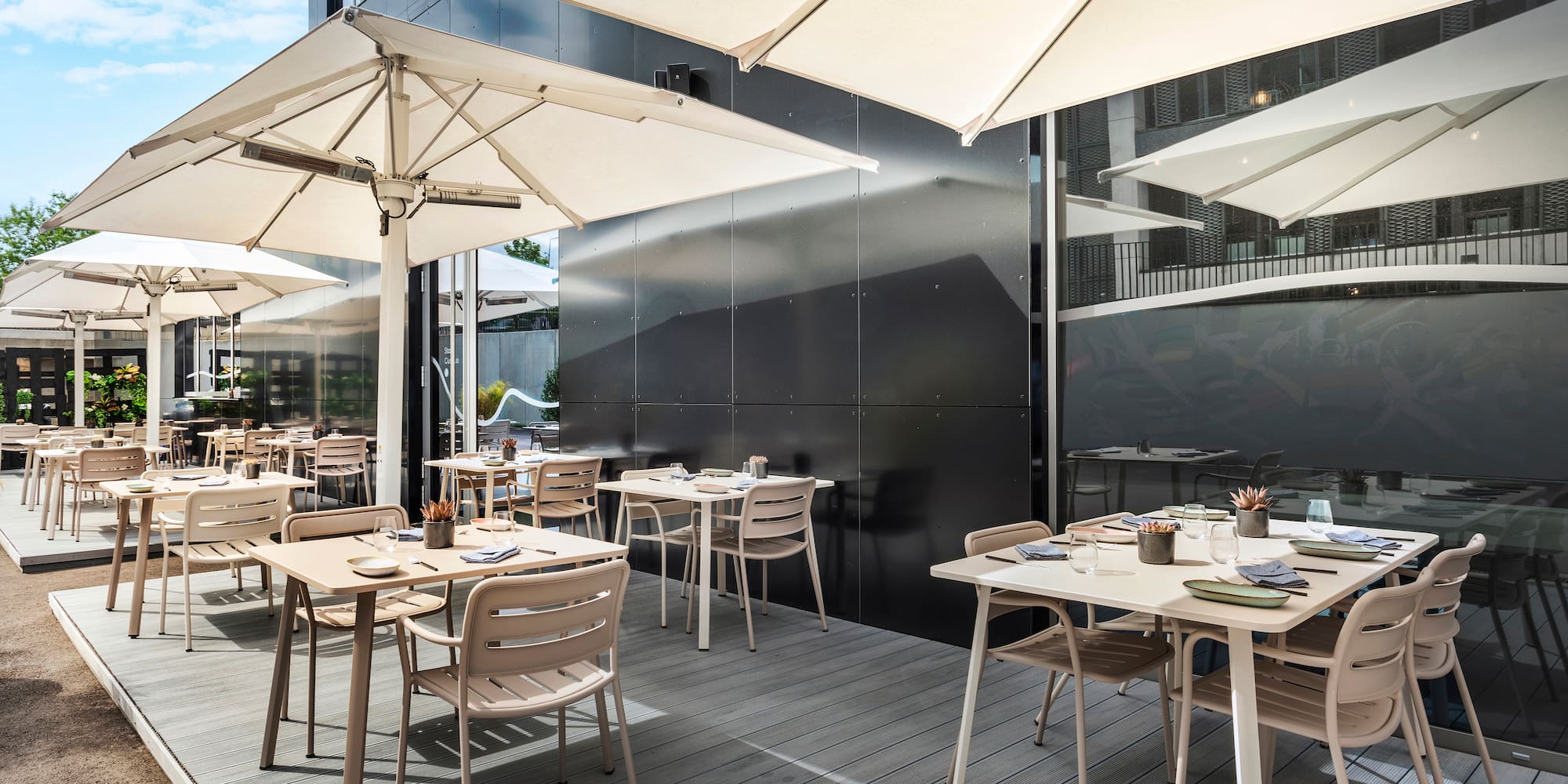 a patio with tables and umbrellas
