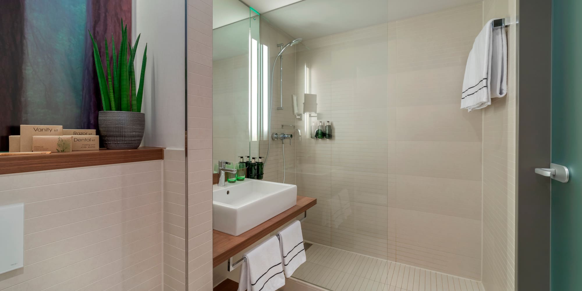 a bathroom with a glass shower and sink