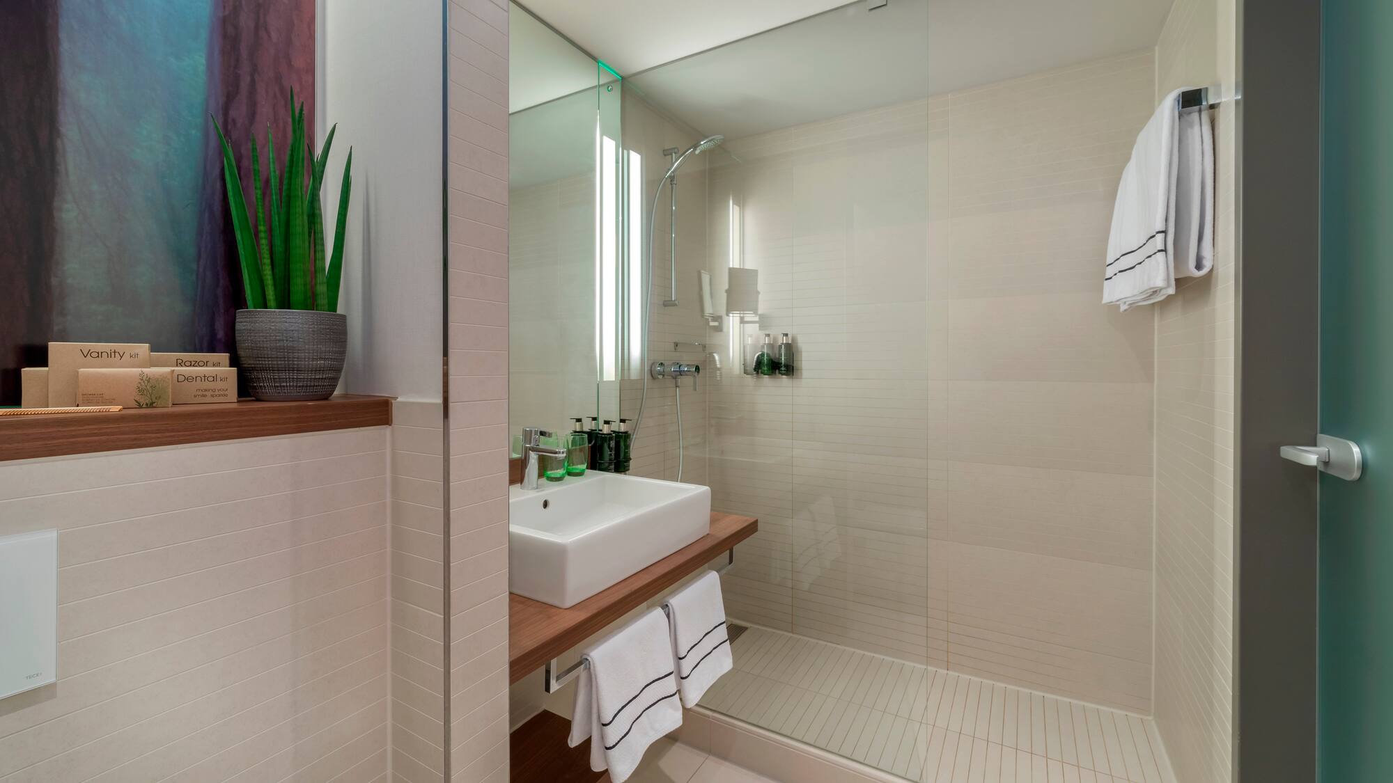 a bathroom with a glass shower and sink