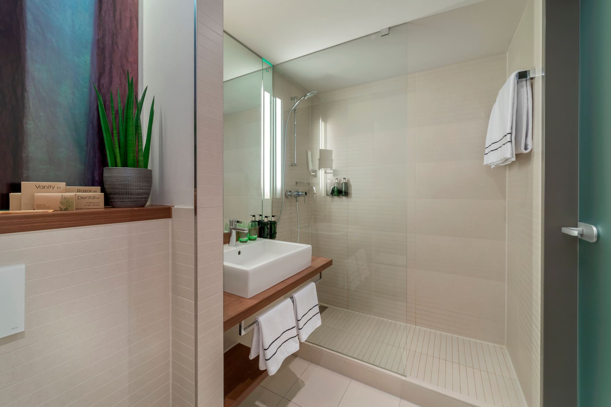 a bathroom with a glass shower and sink