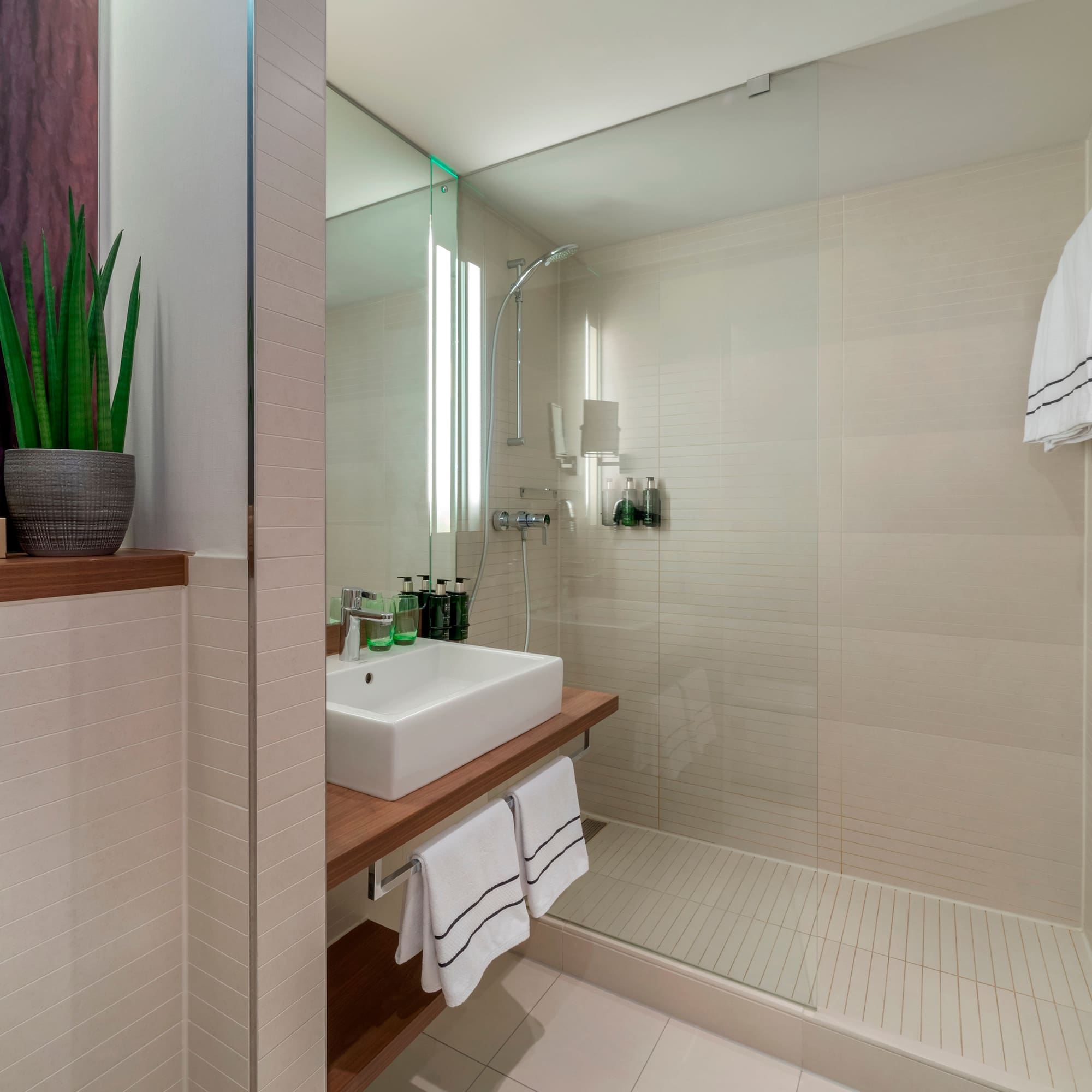 a bathroom with a glass shower and sink