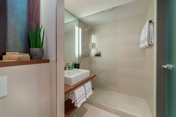 a bathroom with a glass shower and sink