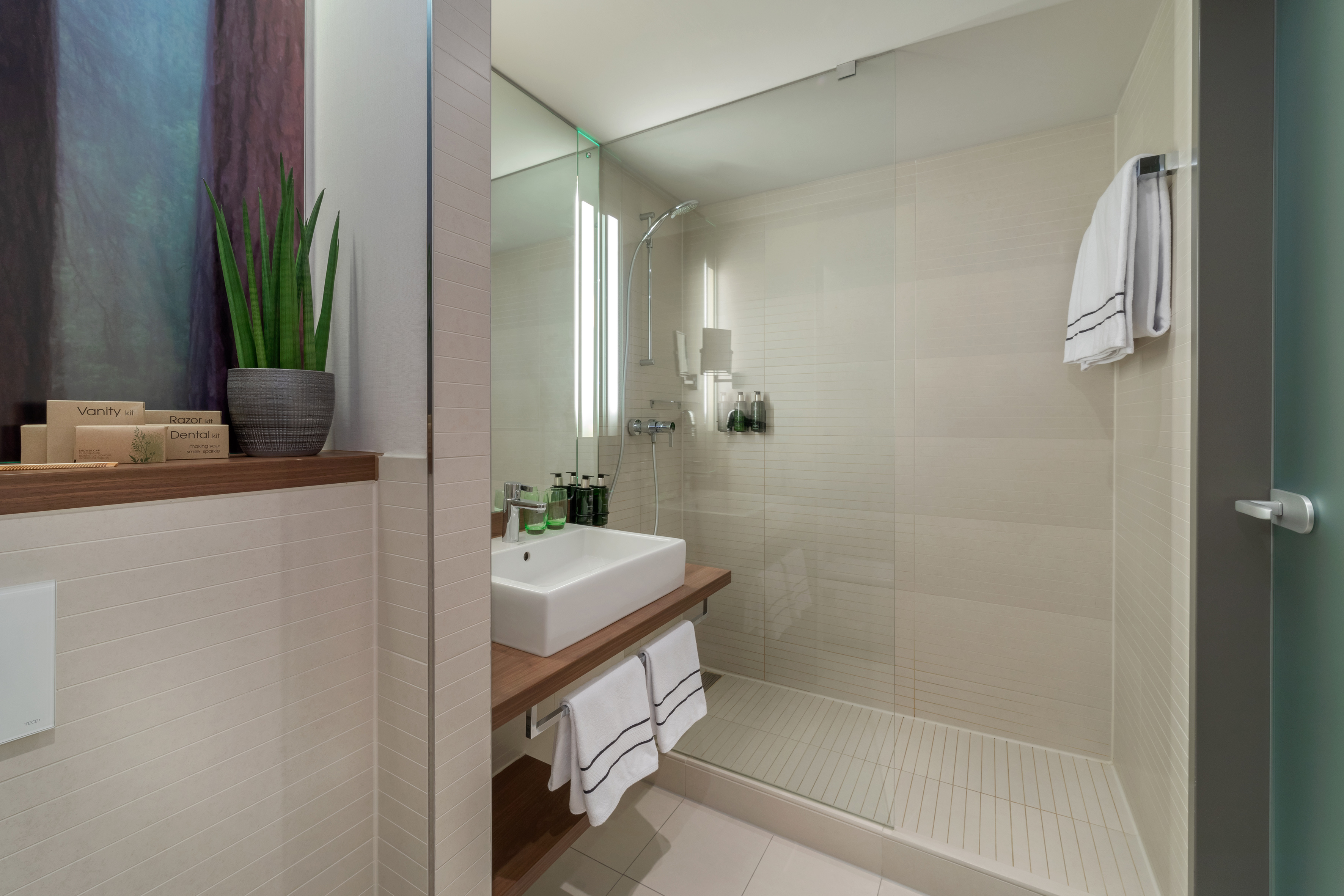 a bathroom with a glass shower and sink