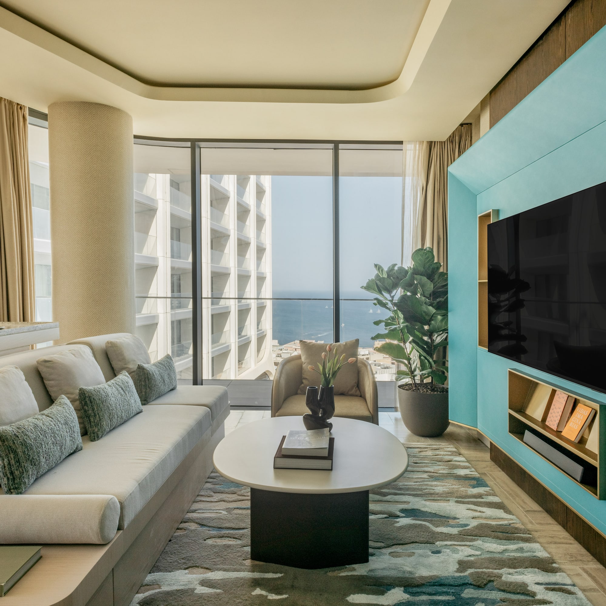 a living room with a large television and a large window