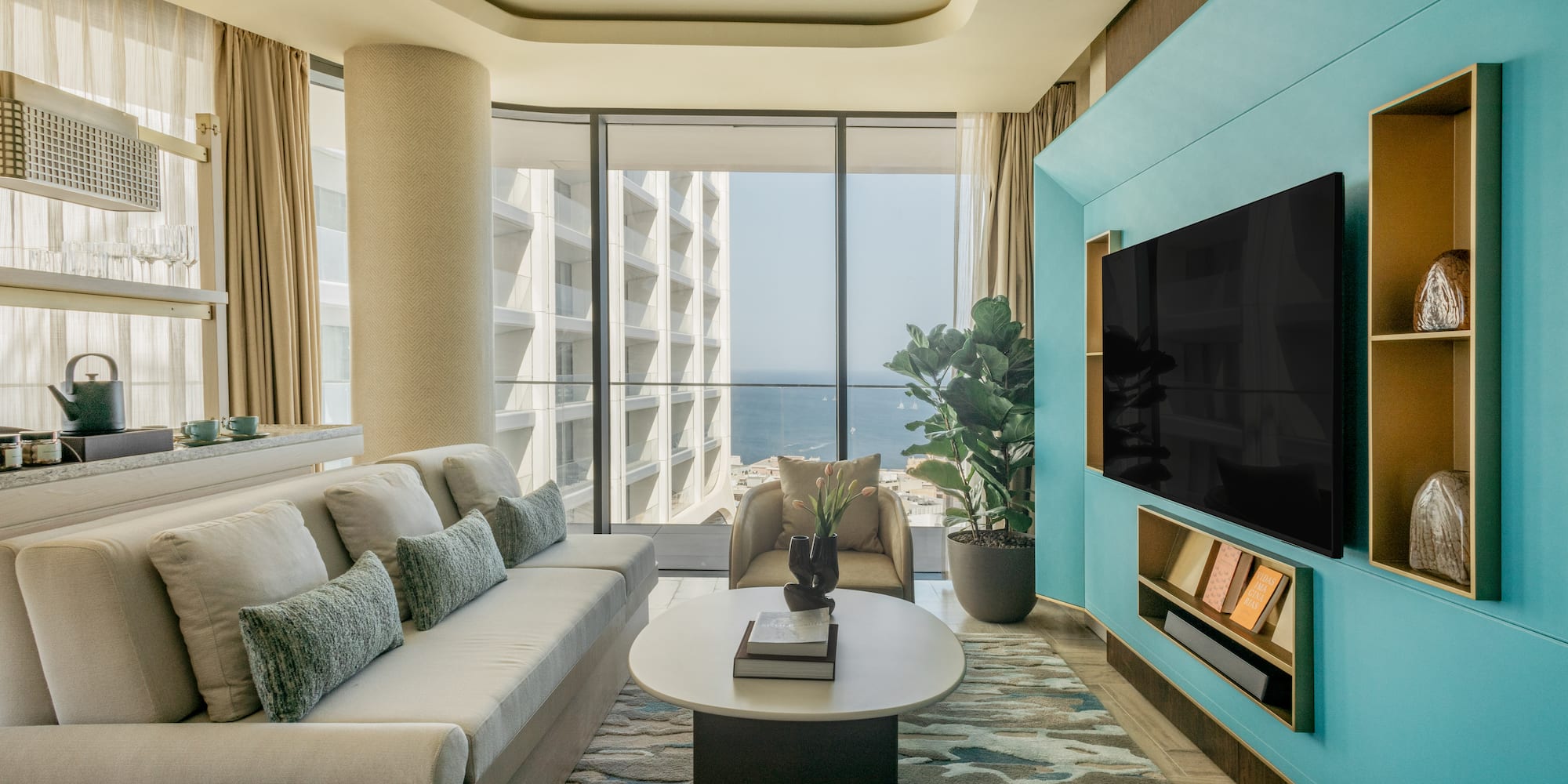 a living room with a large television and a large window