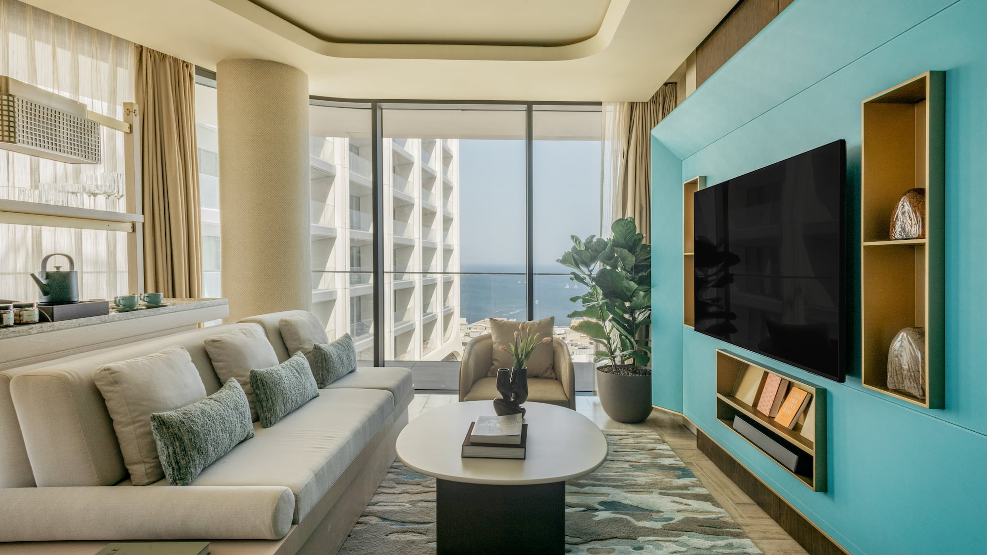 a living room with a large television and a large window