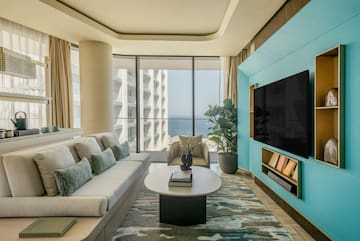 a living room with a large television and a large window