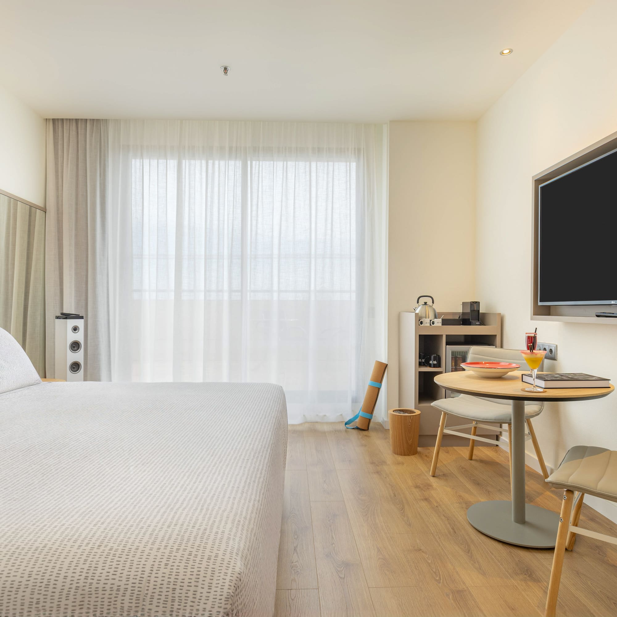 a room with a bed and a table and a tv