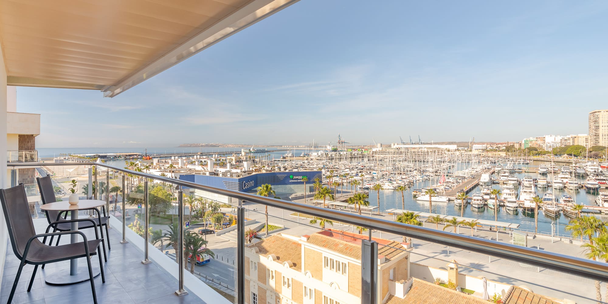 a balcony with a view of a city and a marina
