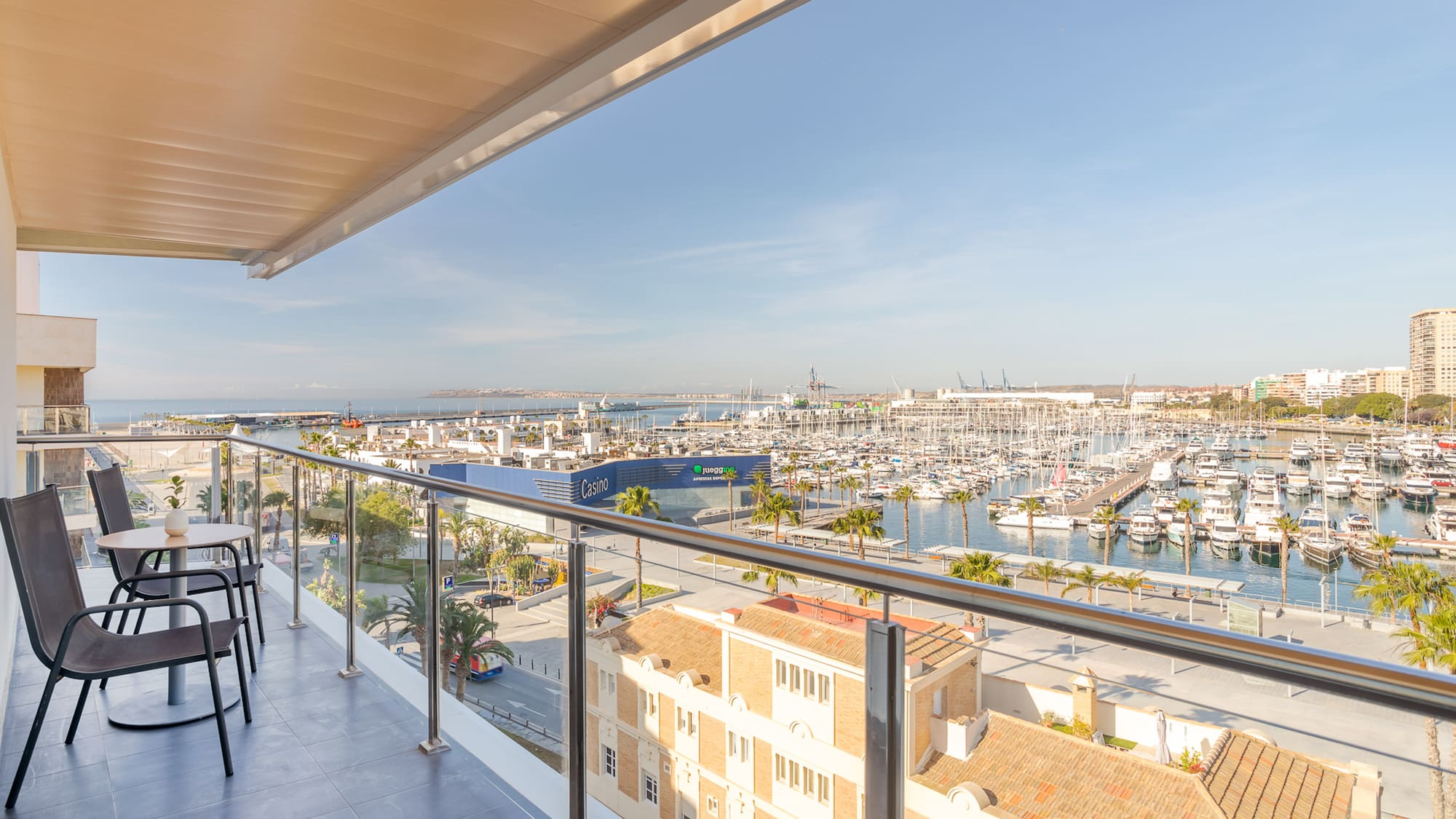 a balcony with a view of a city and a marina