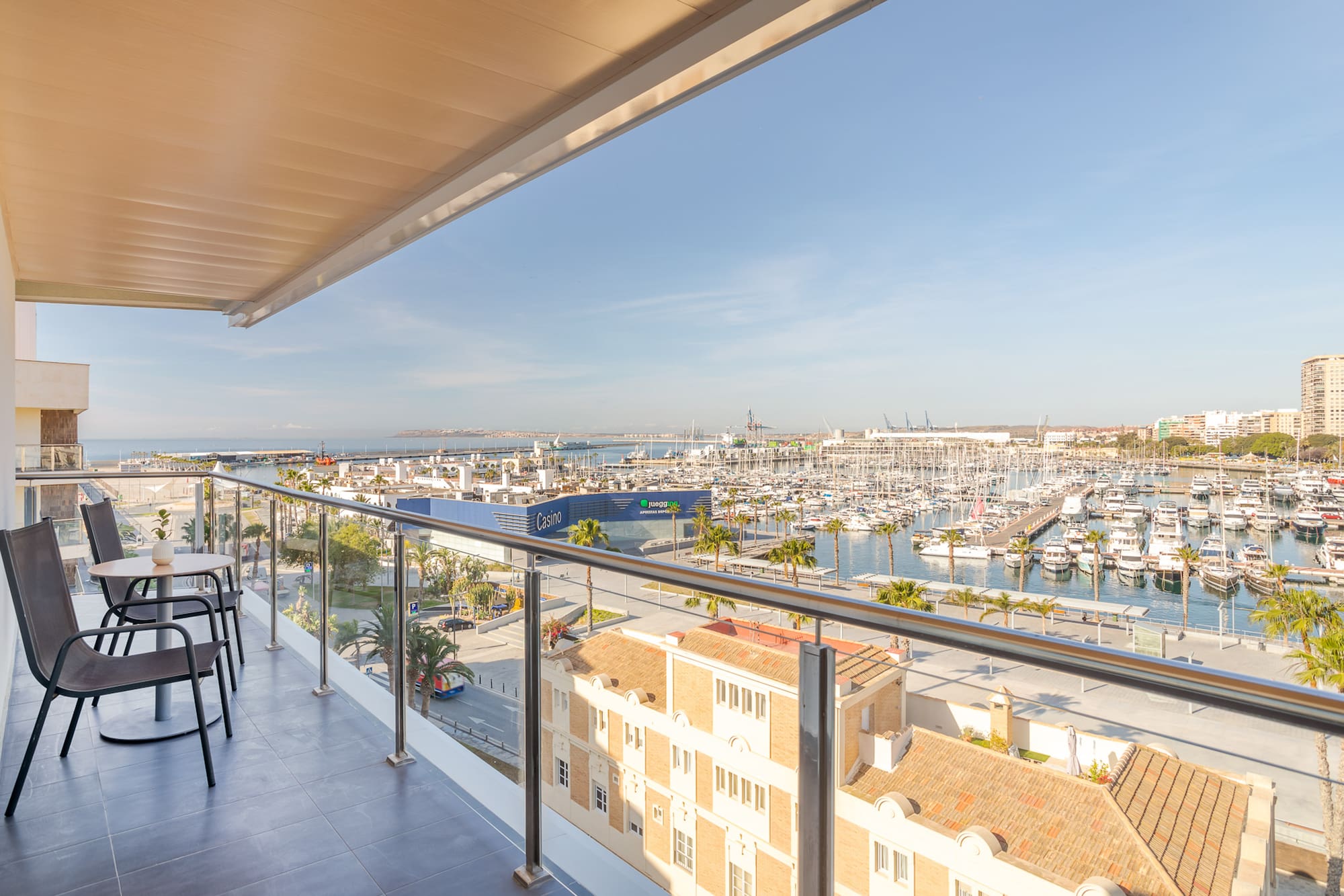 a balcony with a view of a city and a marina