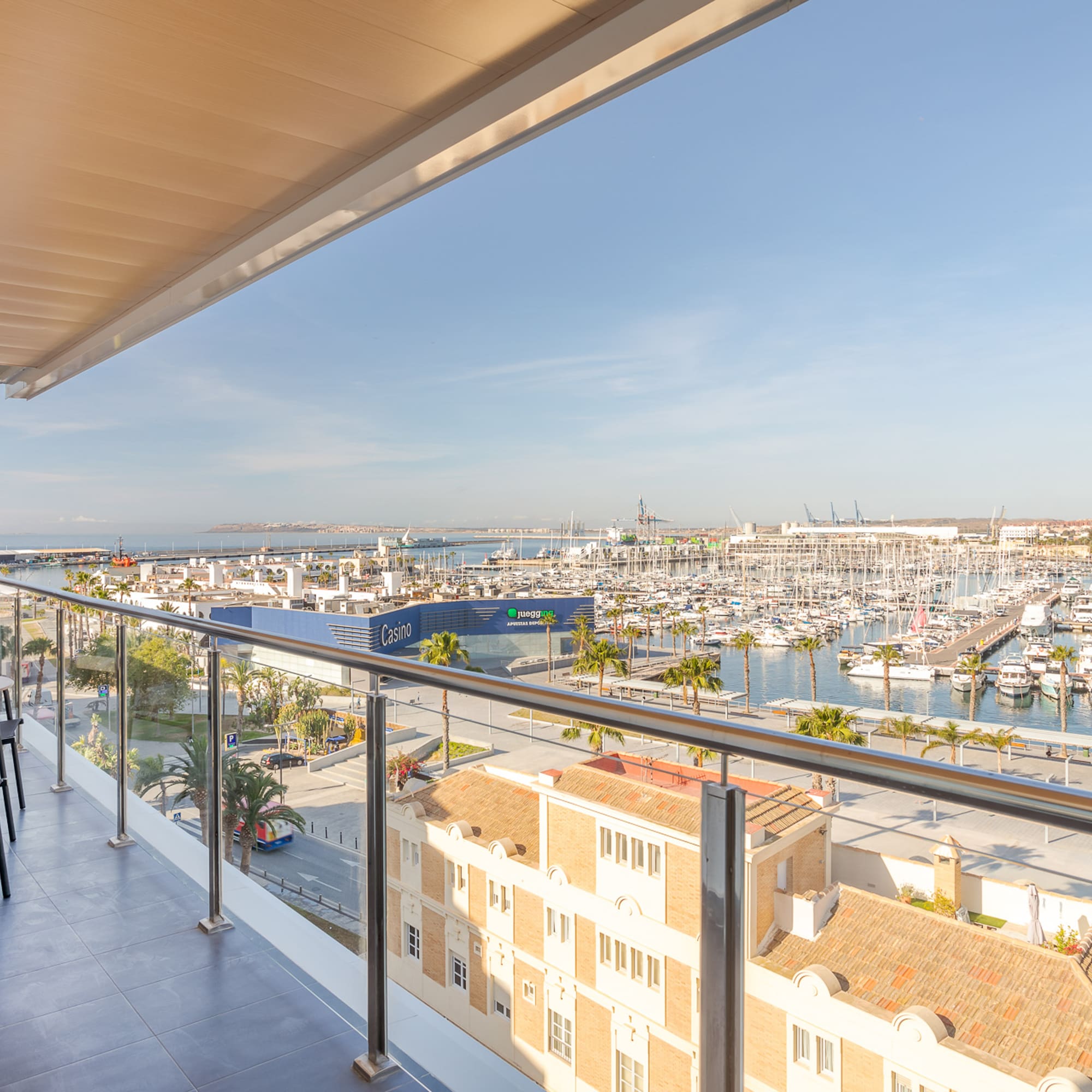 a balcony with a view of a city and a marina