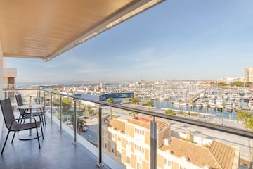 a balcony with a view of a city and a marina