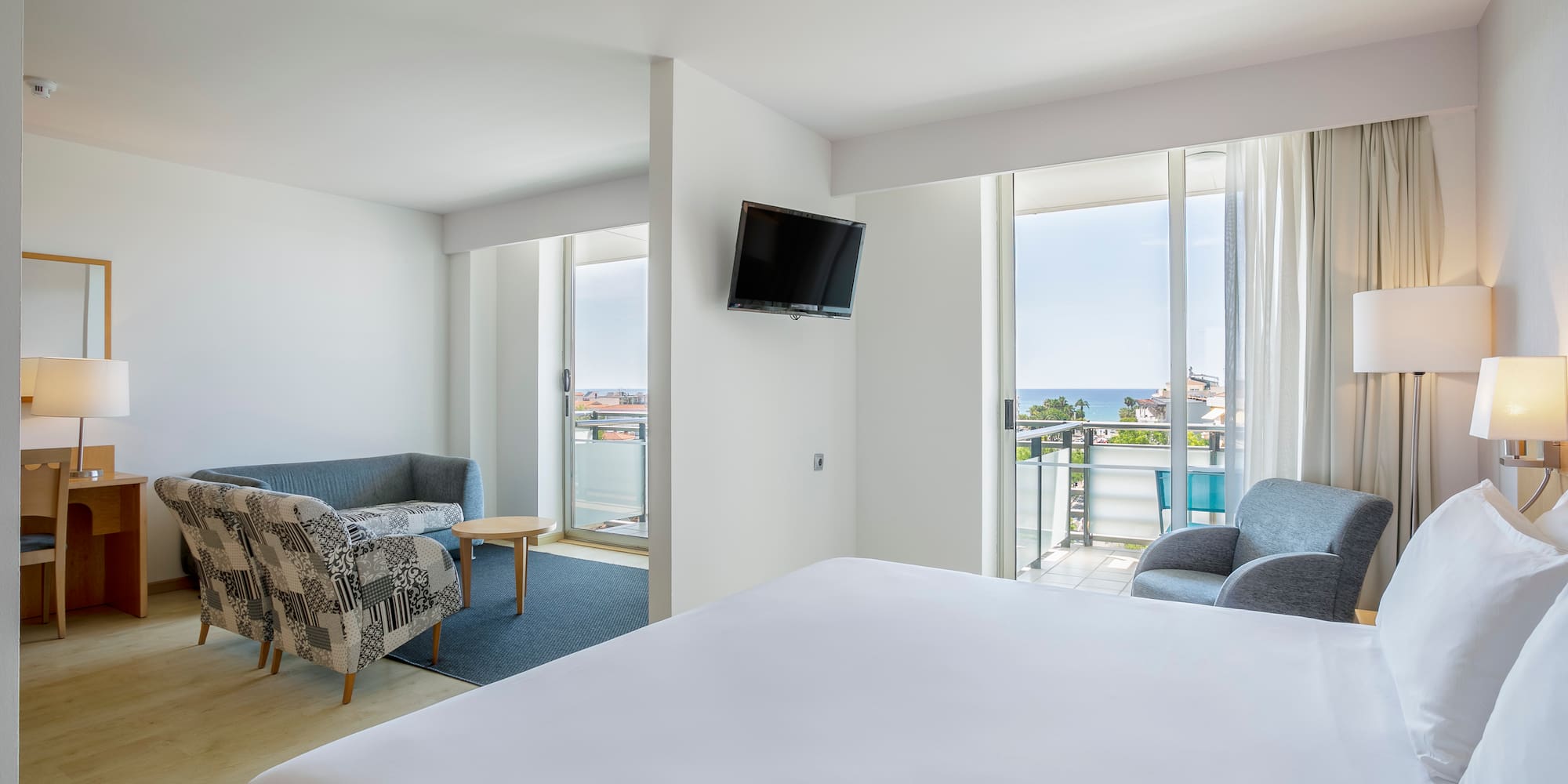 a room with a bed and a television