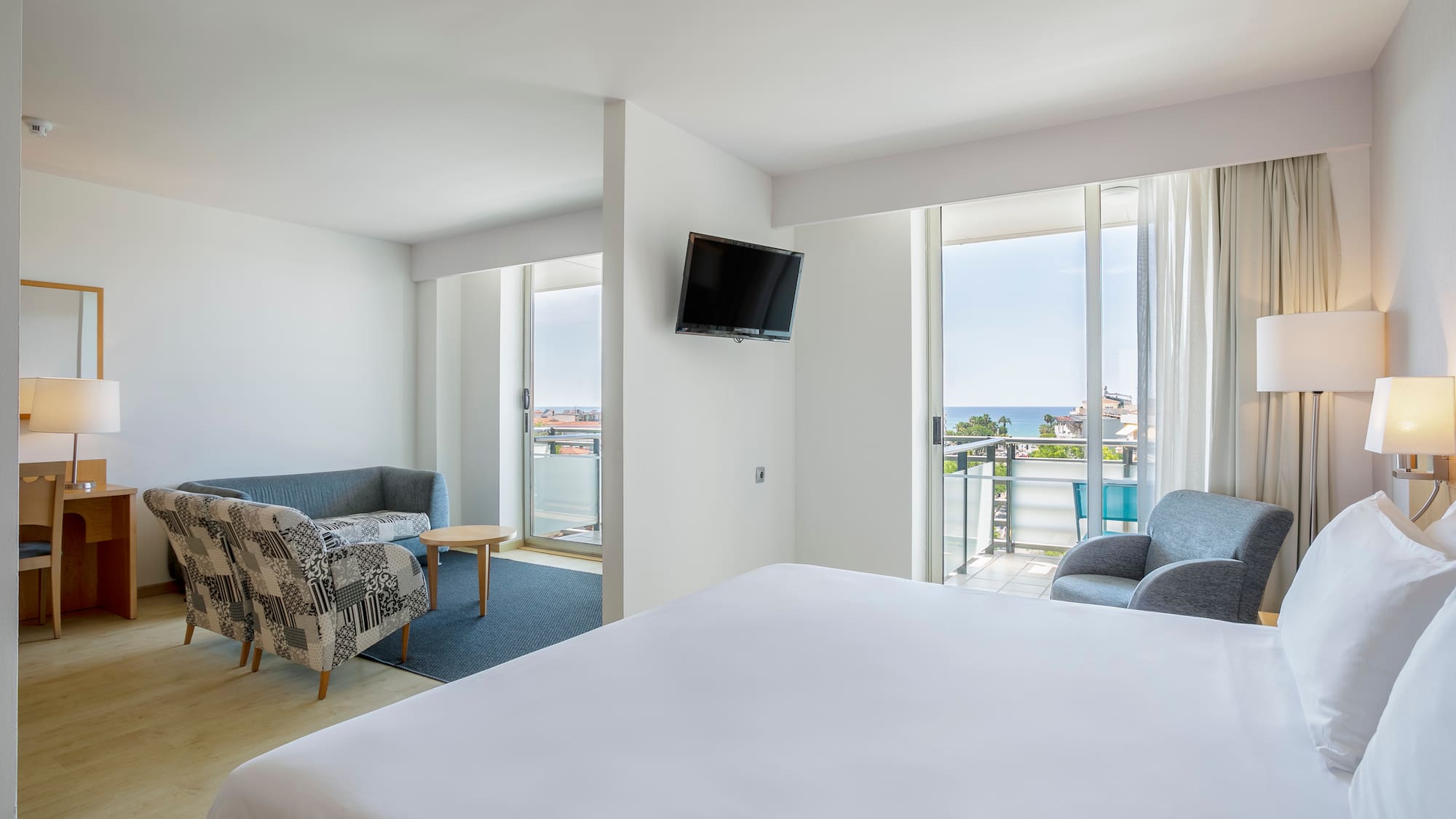 a room with a bed and a television