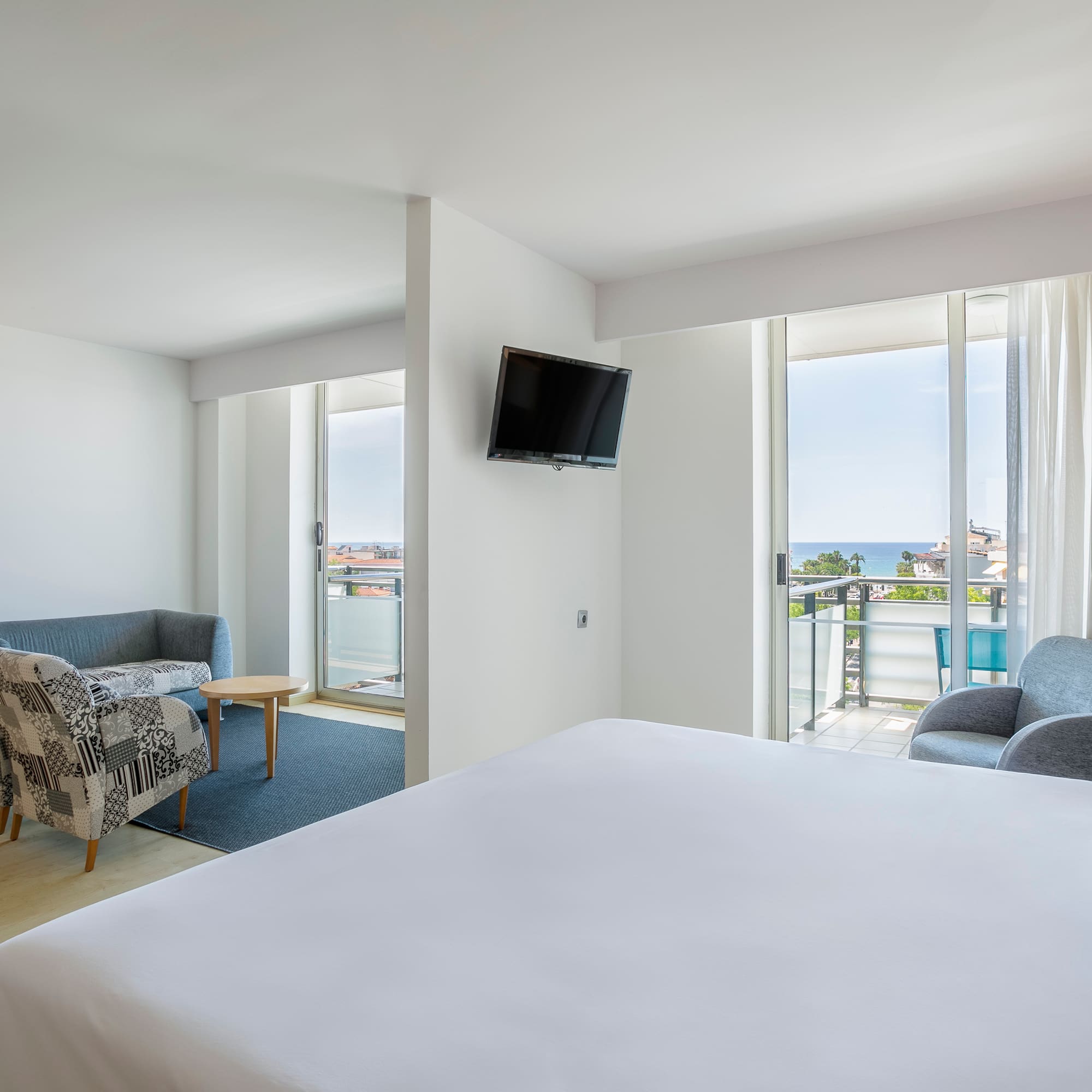 a room with a bed and a television