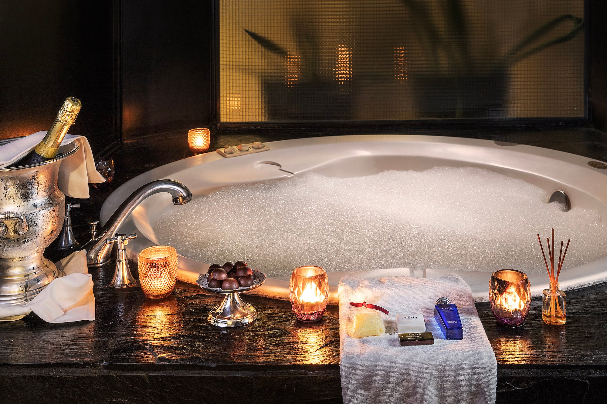 a bathtub with candles and soaps