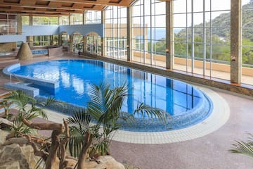 a indoor pool with large windows