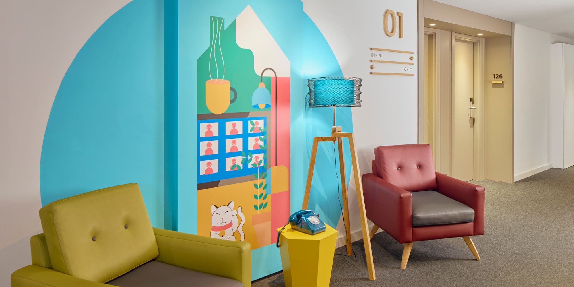 a room with chairs and a wall mural