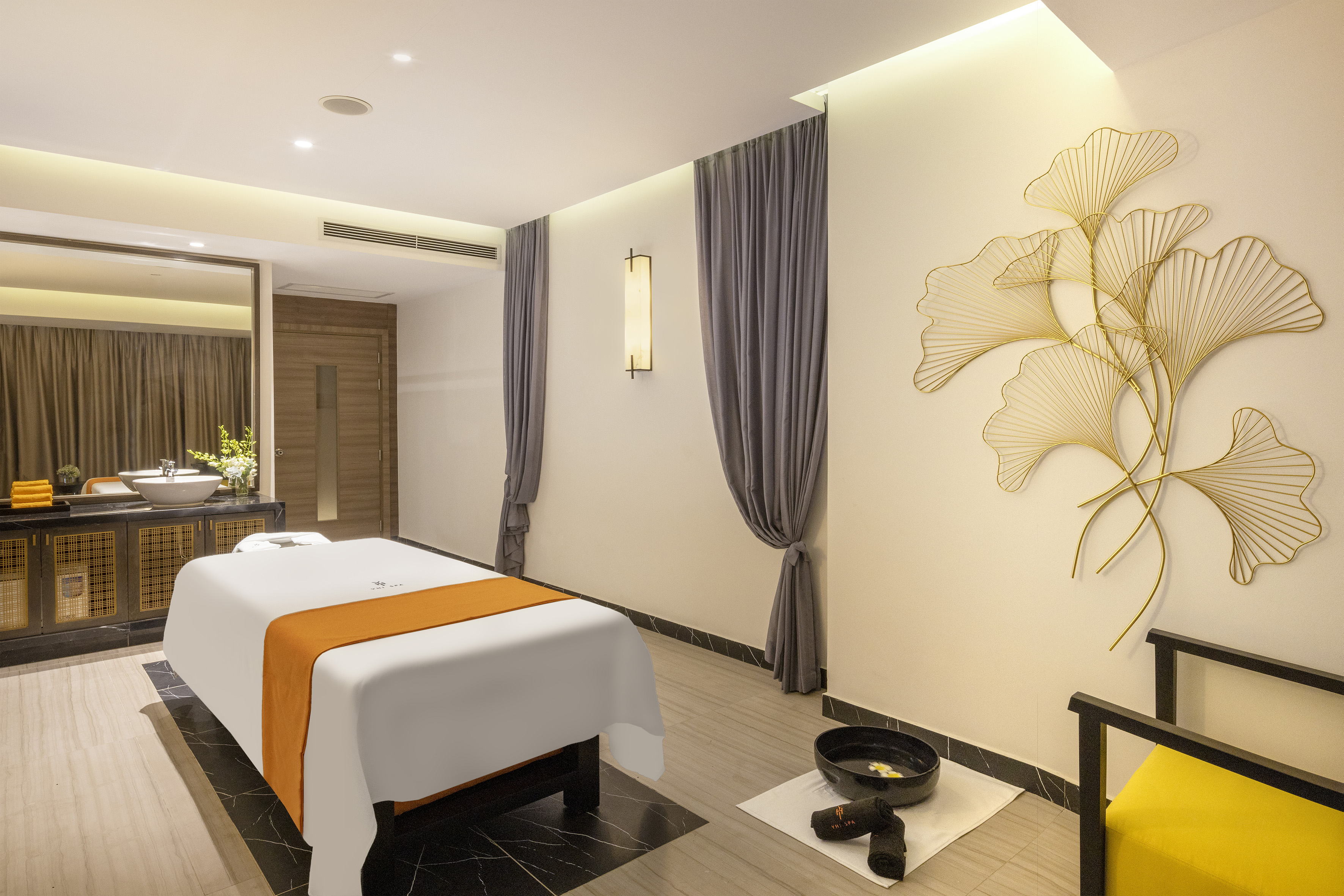 Serene luxury spa room with massage bed, golden ginkgo wall art, and modern decor. - YHI Spa - Meliá Vinpearl Thanh Hoa, Thanh Hoa