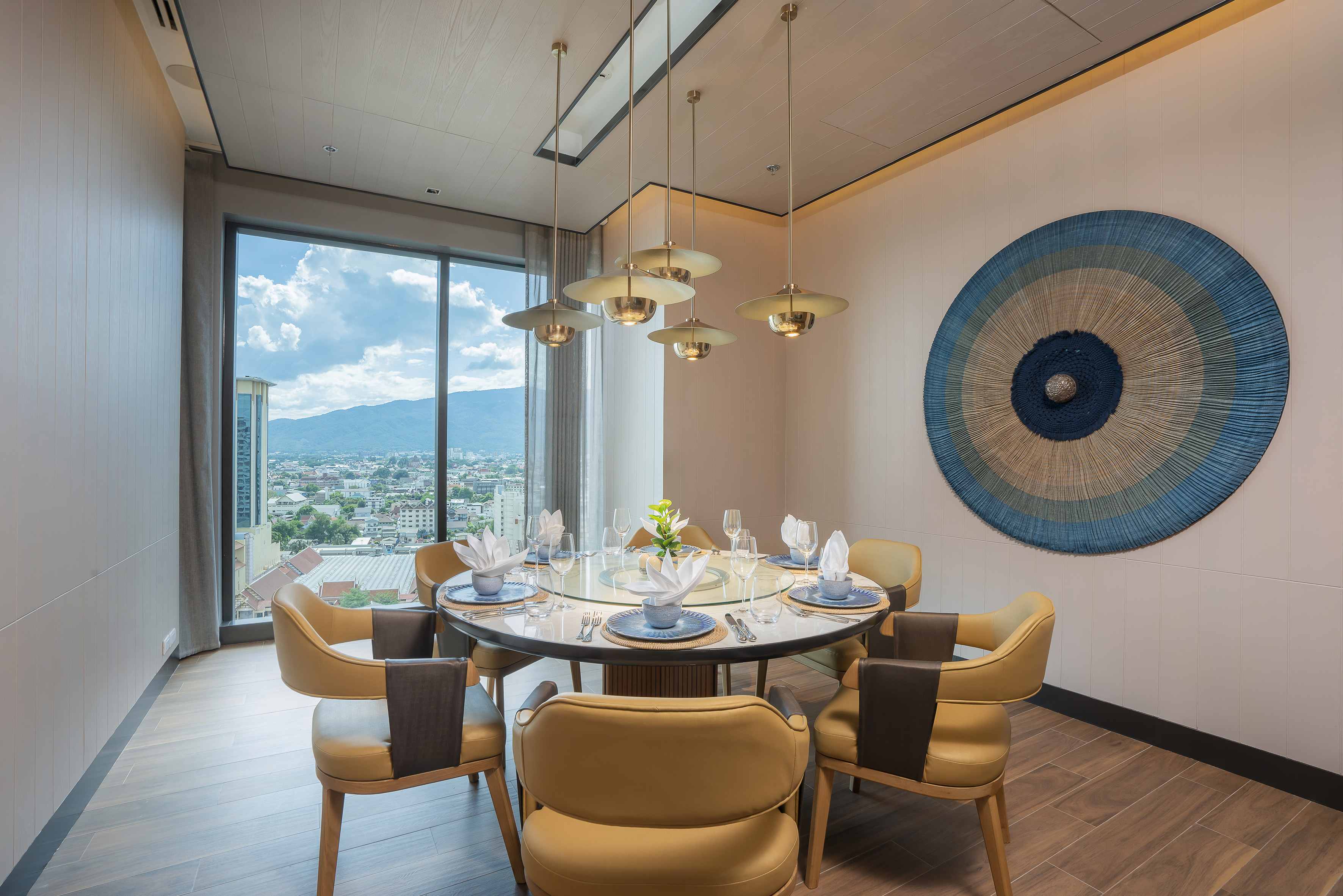 Elegant private dining room, city mountain view, round table, modern decor.