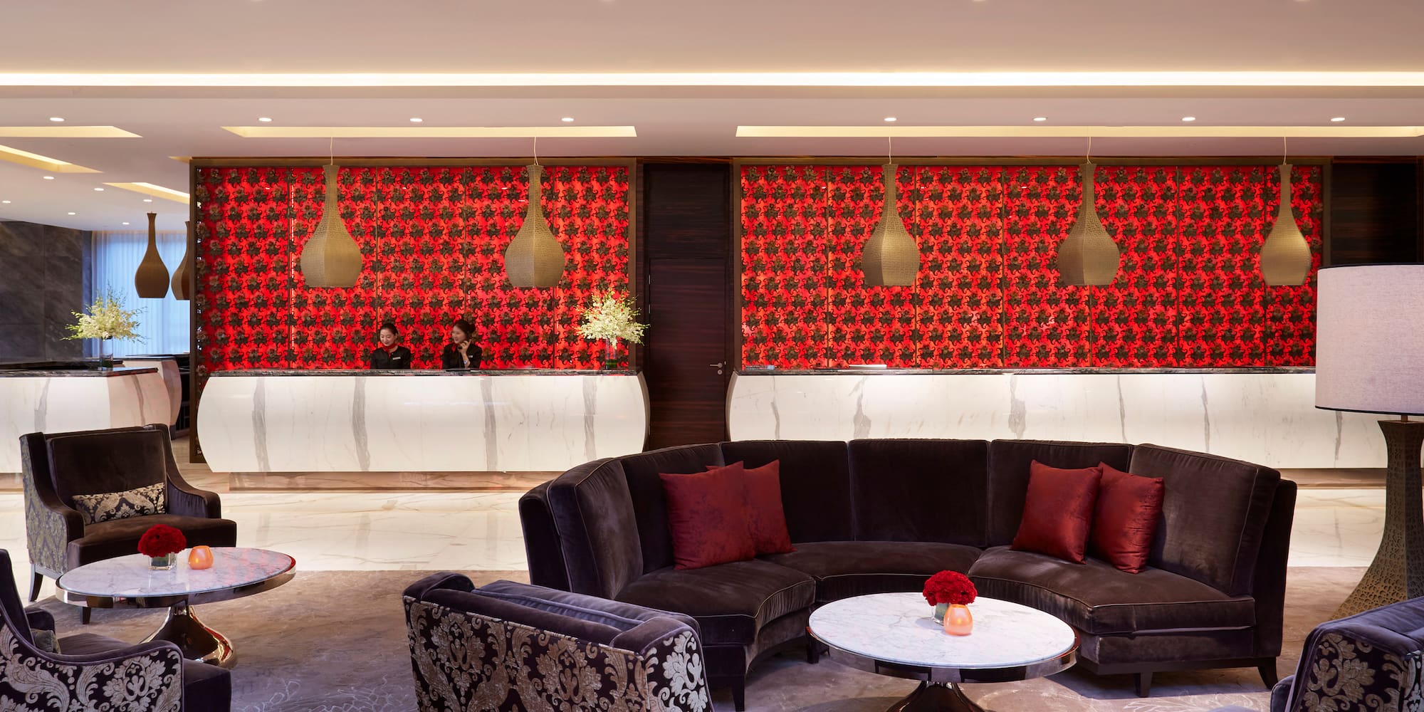 a room with a round table and couches