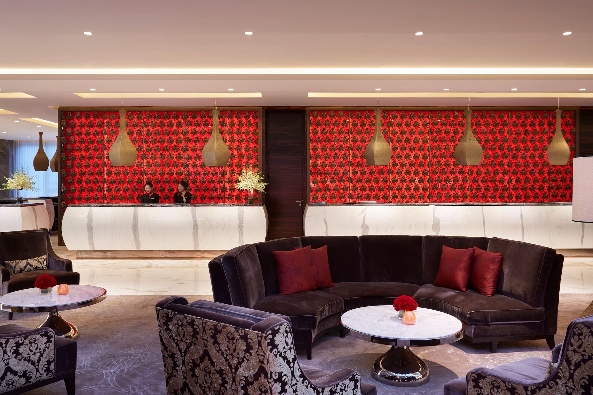 a room with a round table and couches