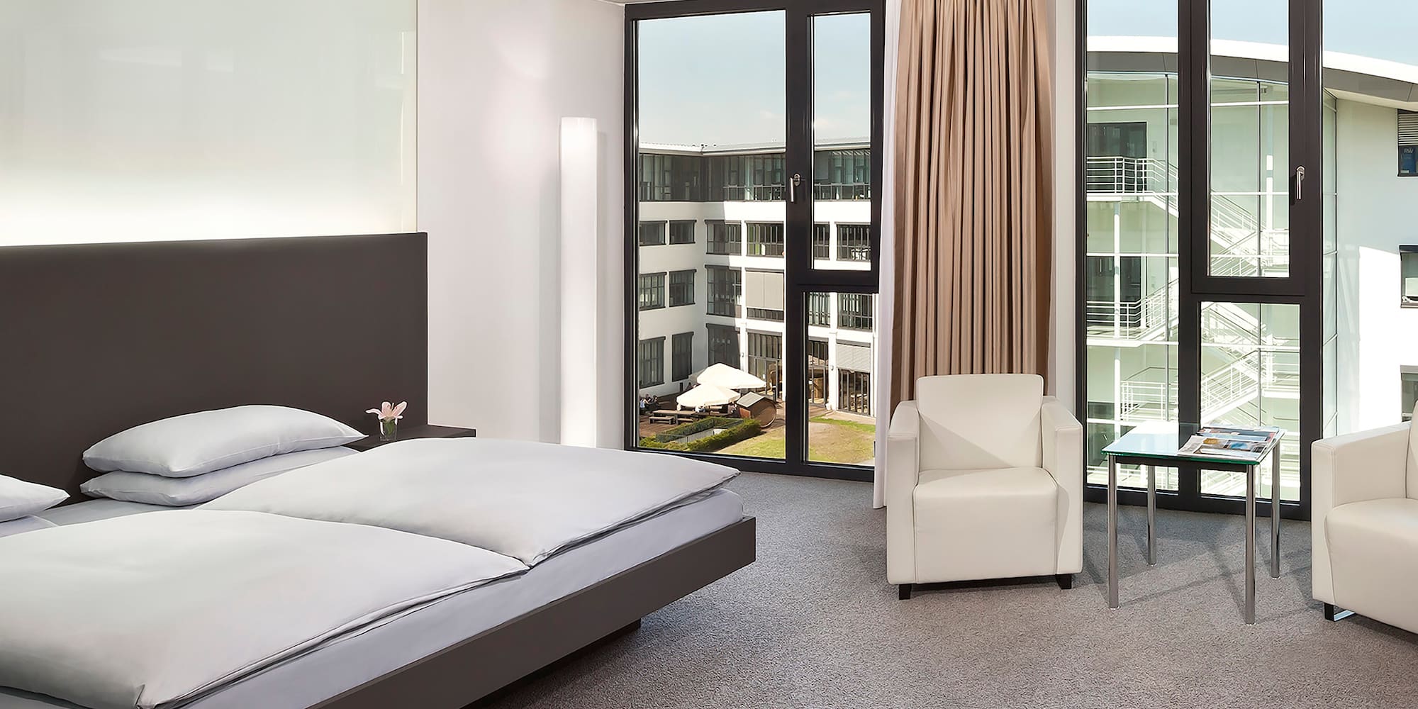 a bedroom with a bed and chairs