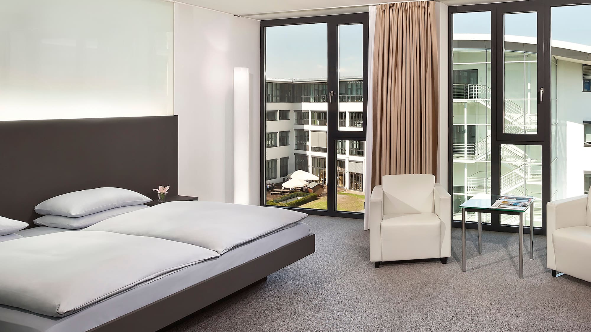 a bedroom with a bed and chairs