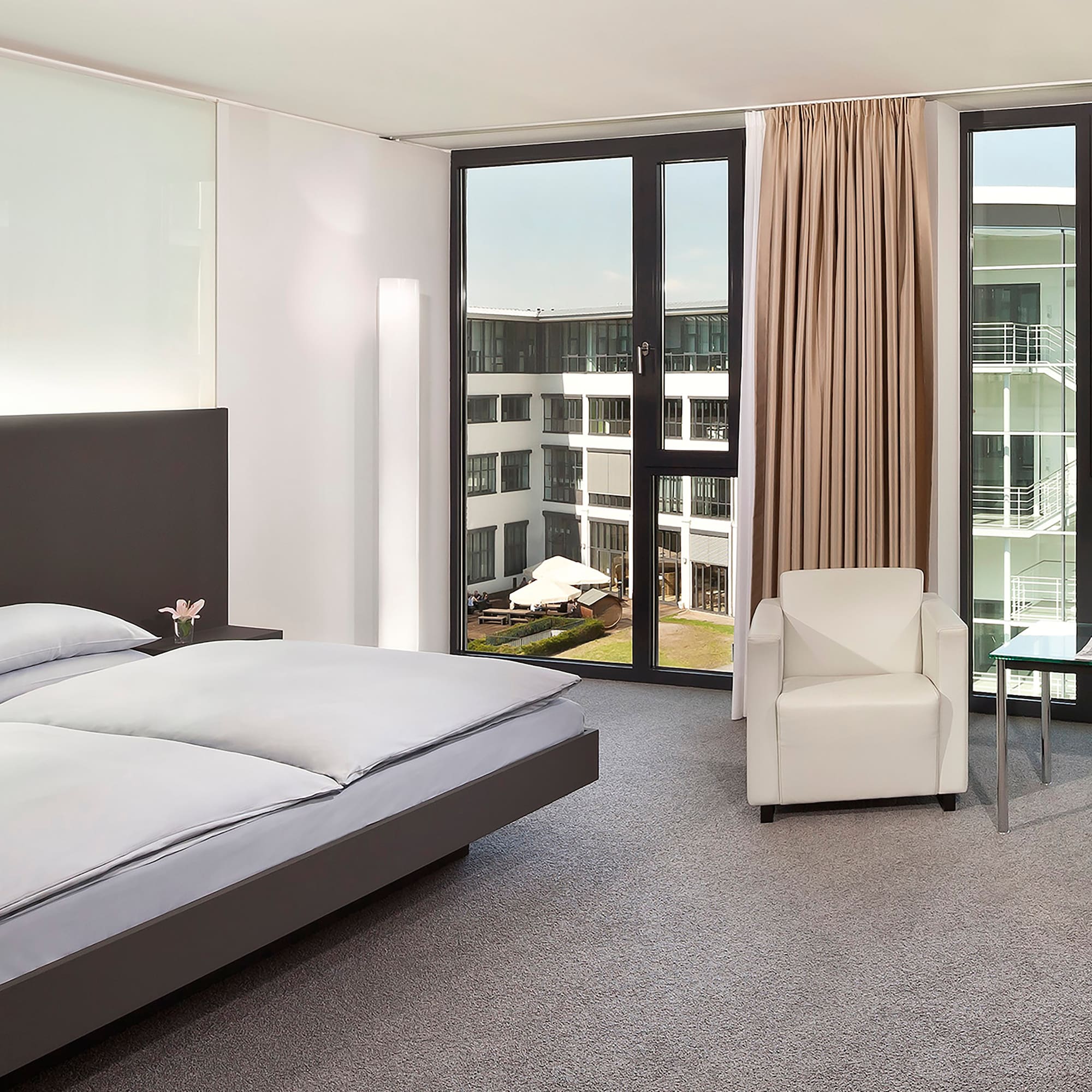 a bedroom with a bed and chairs