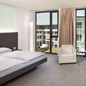 a bedroom with a bed and chairs