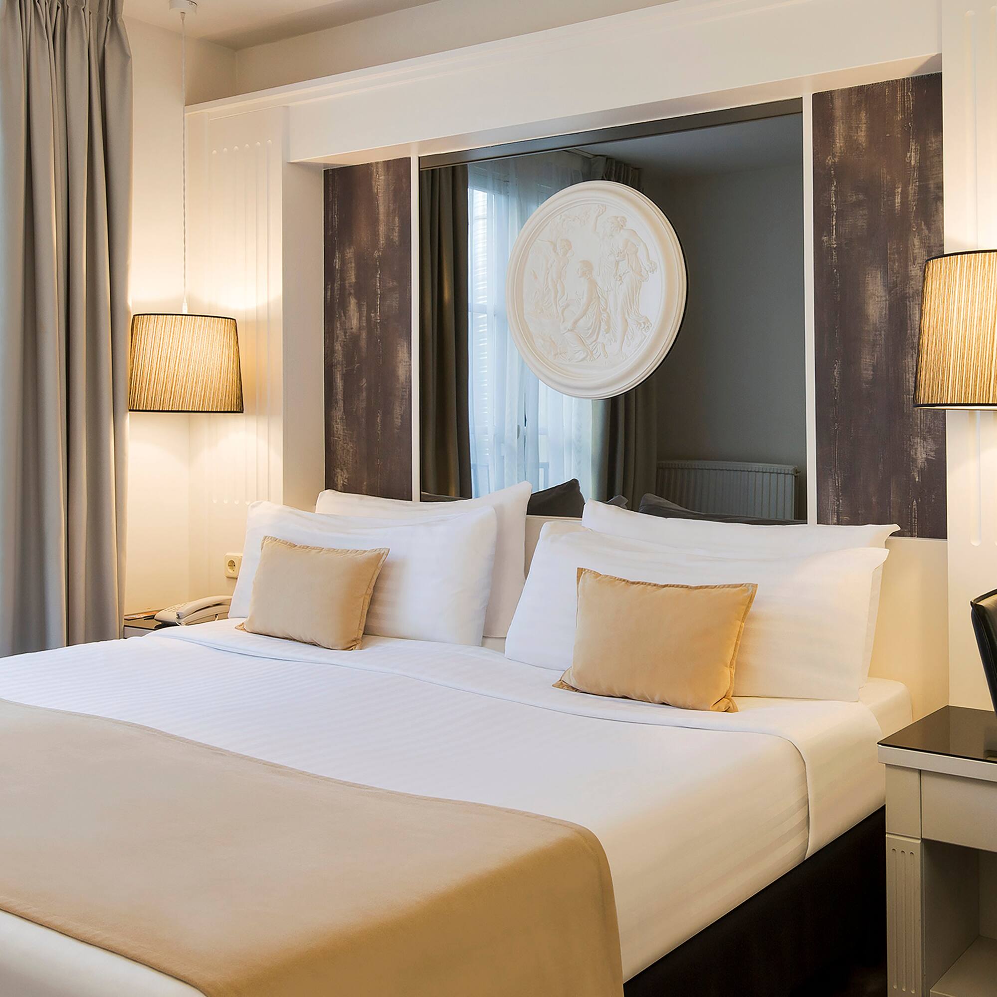 a bed with a mirror above it