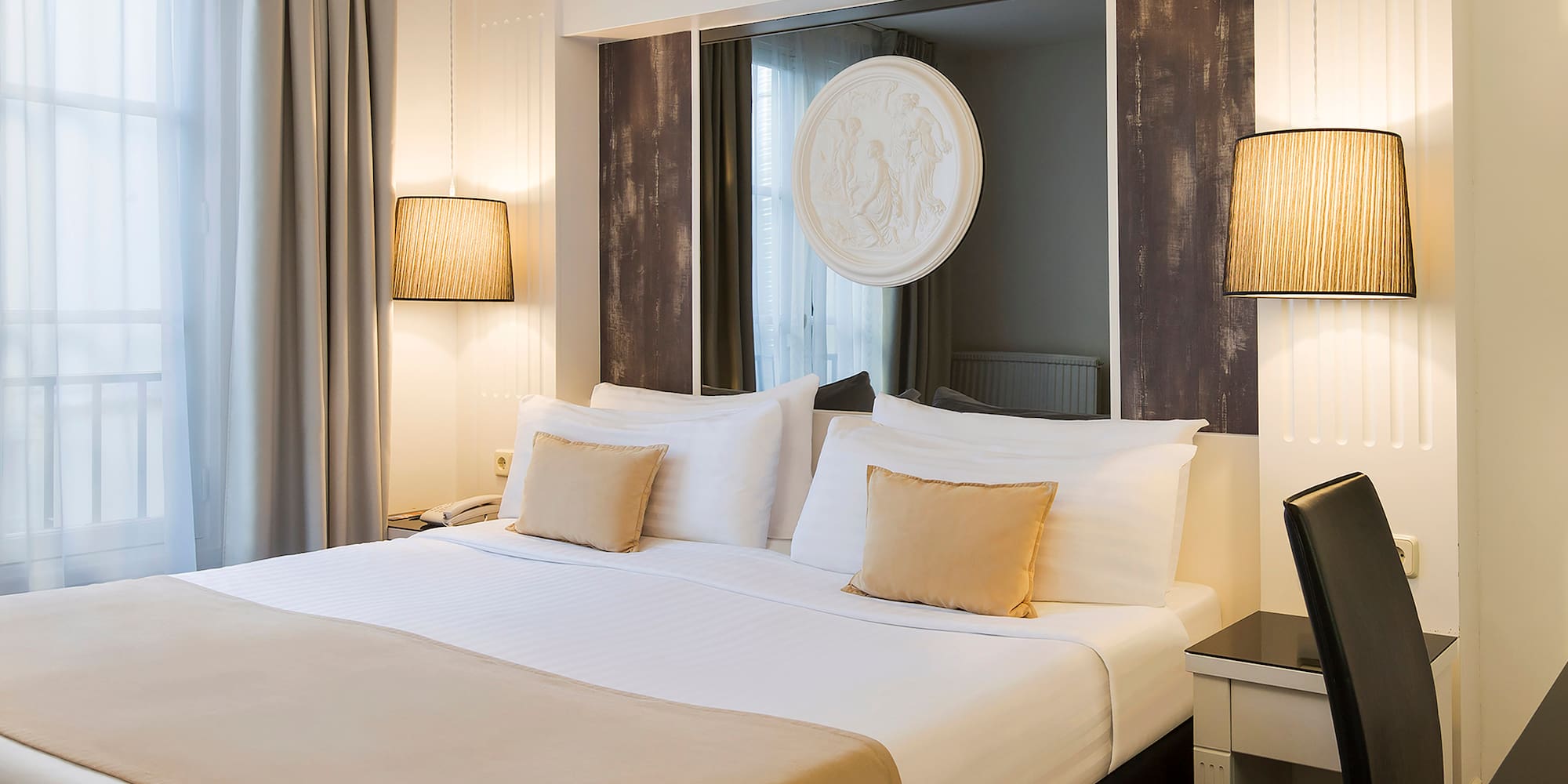 a bed with a mirror above it