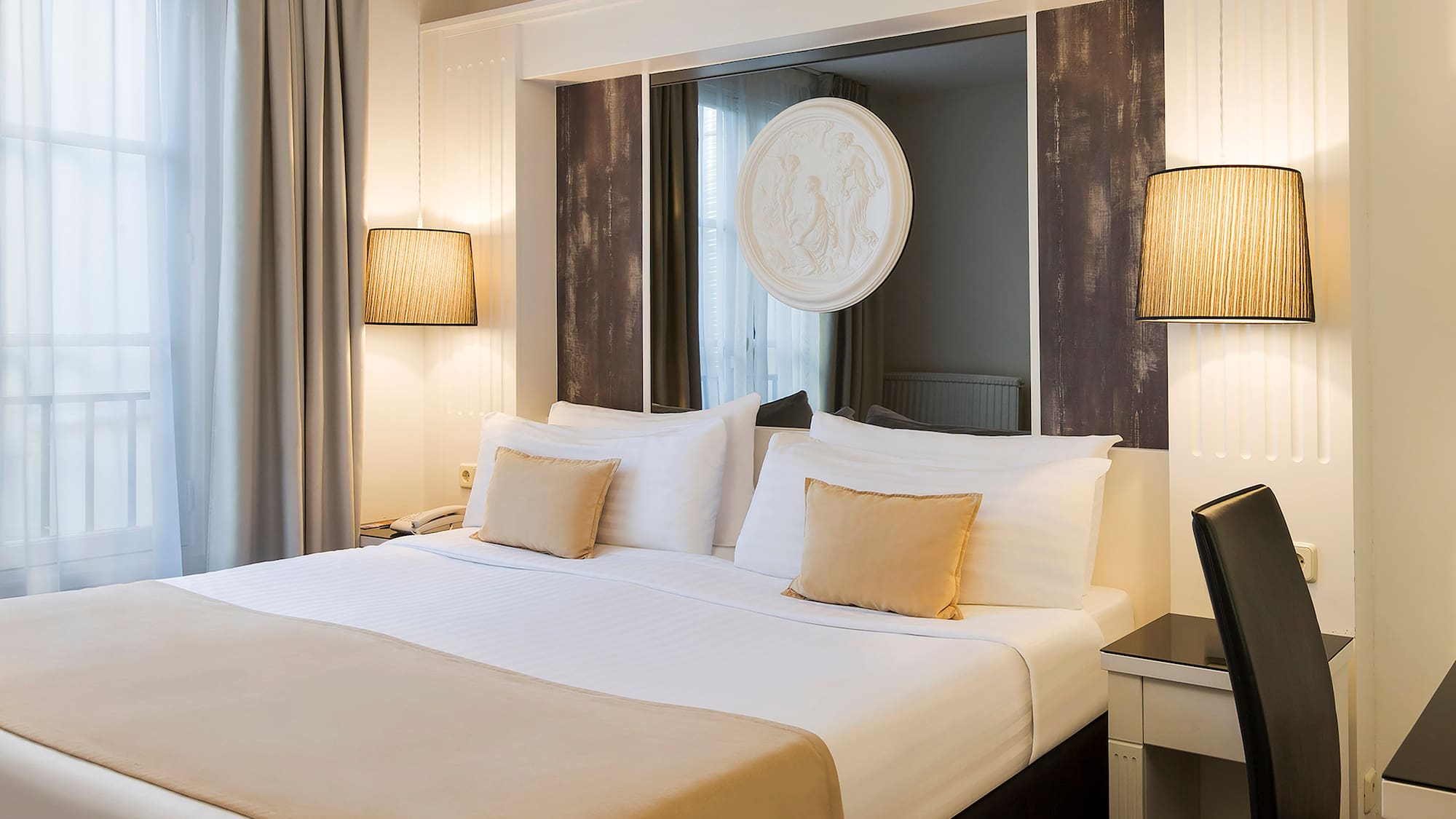 a bed with a mirror above it