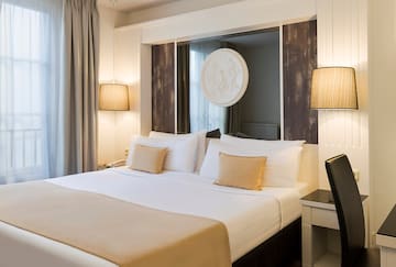 a bed with a mirror above it