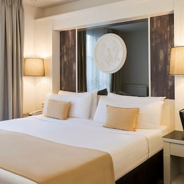 a bed with a mirror above it