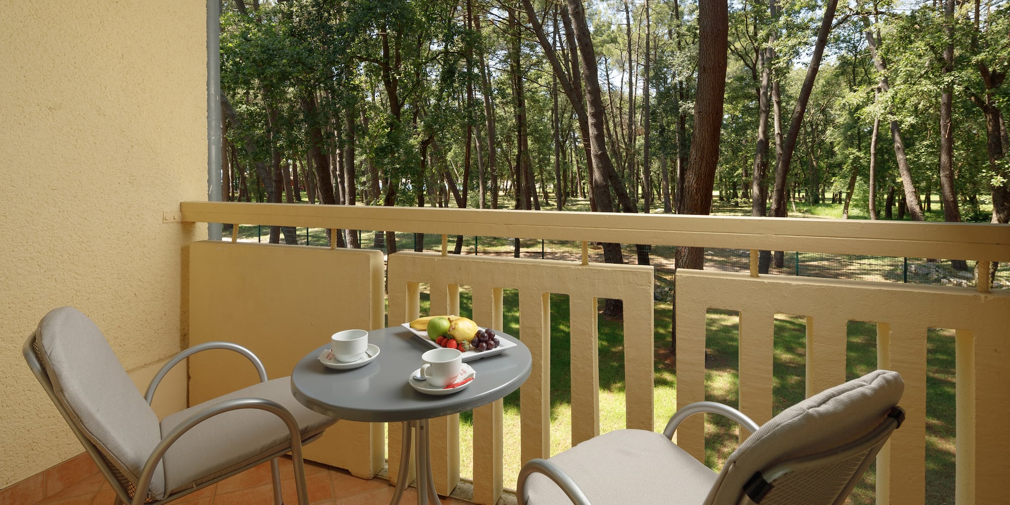 a table and chairs on a balcony