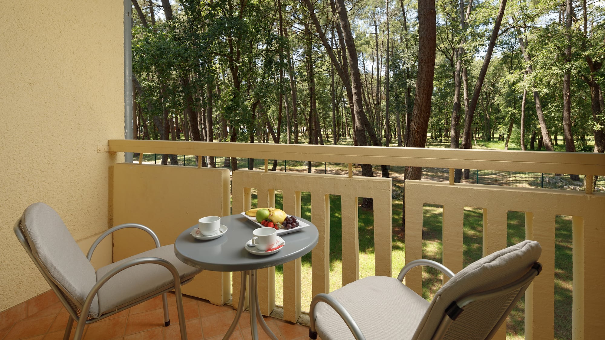 a table and chairs on a balcony