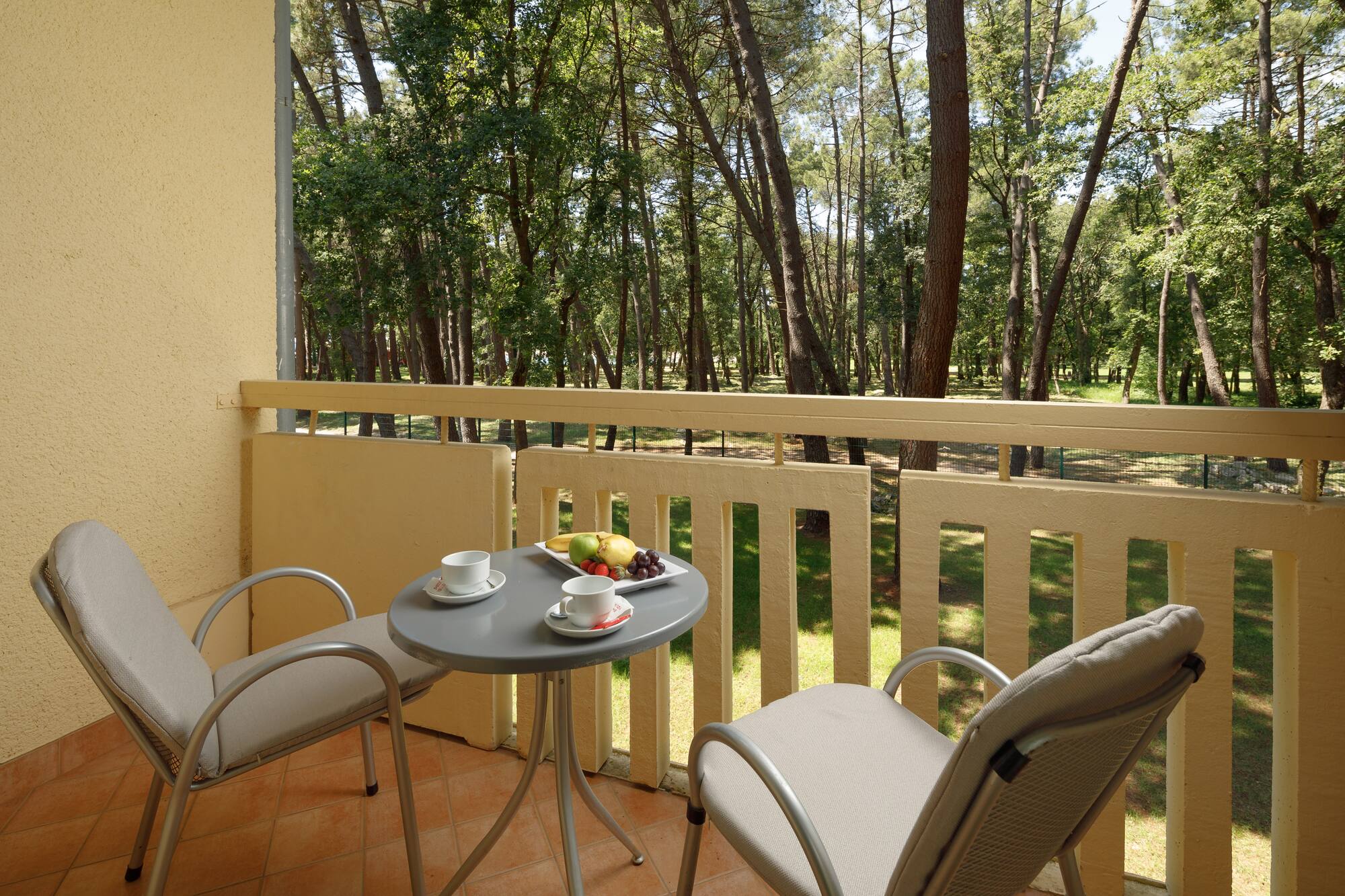 a table and chairs on a balcony