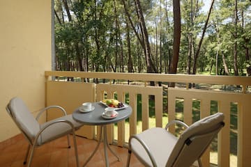 a table and chairs on a balcony
