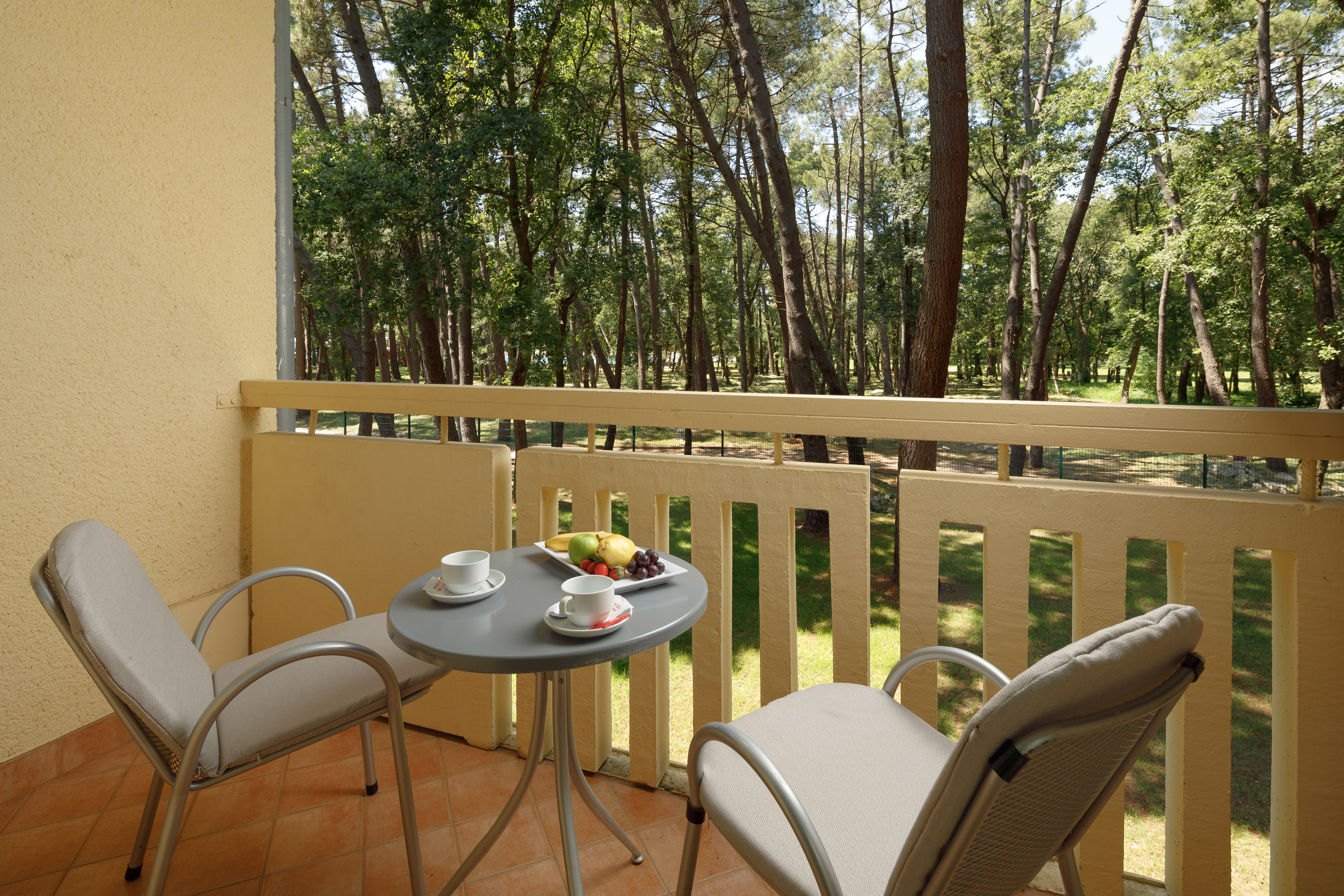 a table and chairs on a balcony