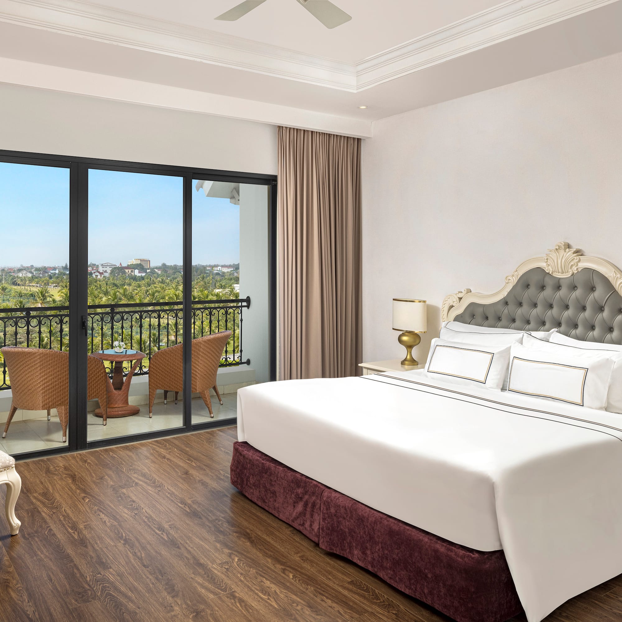 a bedroom with a balcony and a view of the city