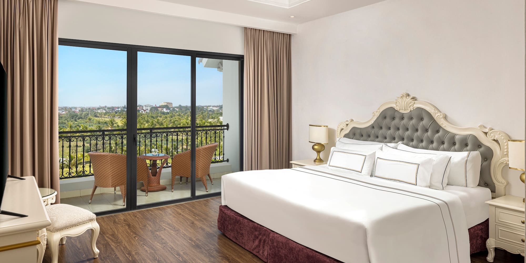 a bedroom with a balcony and a view of the city