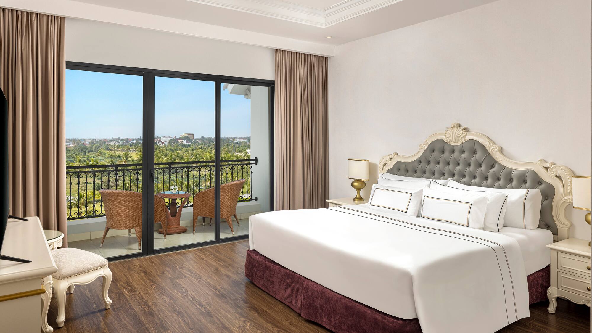 a bedroom with a balcony and a view of the city