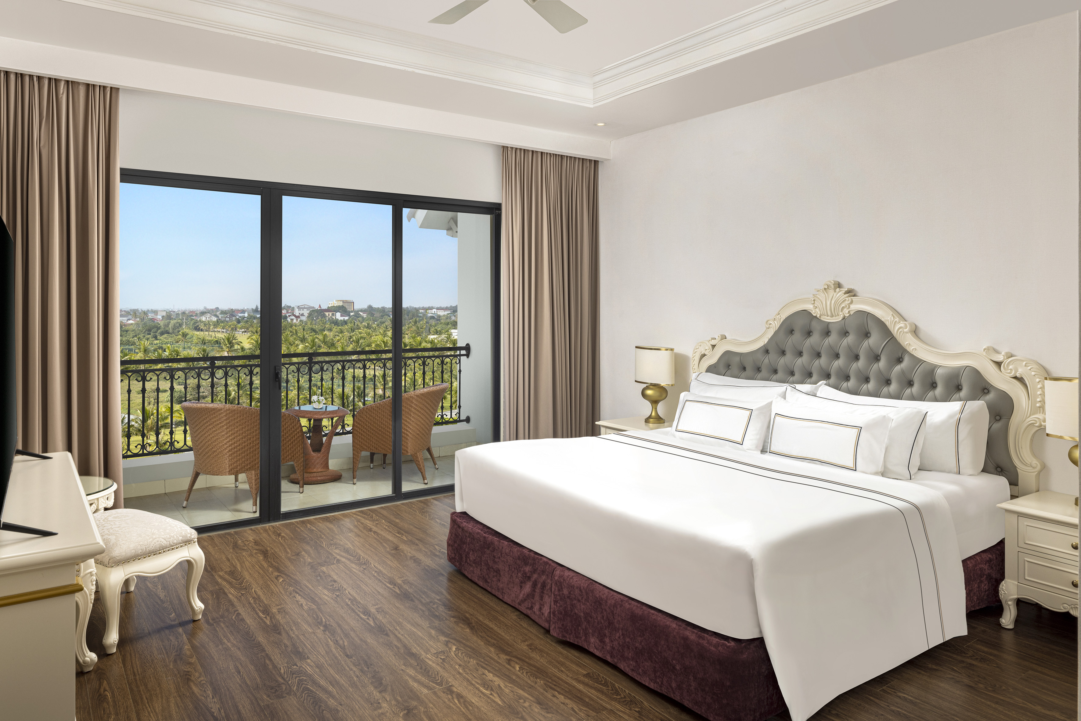 a bedroom with a balcony and a view of the city